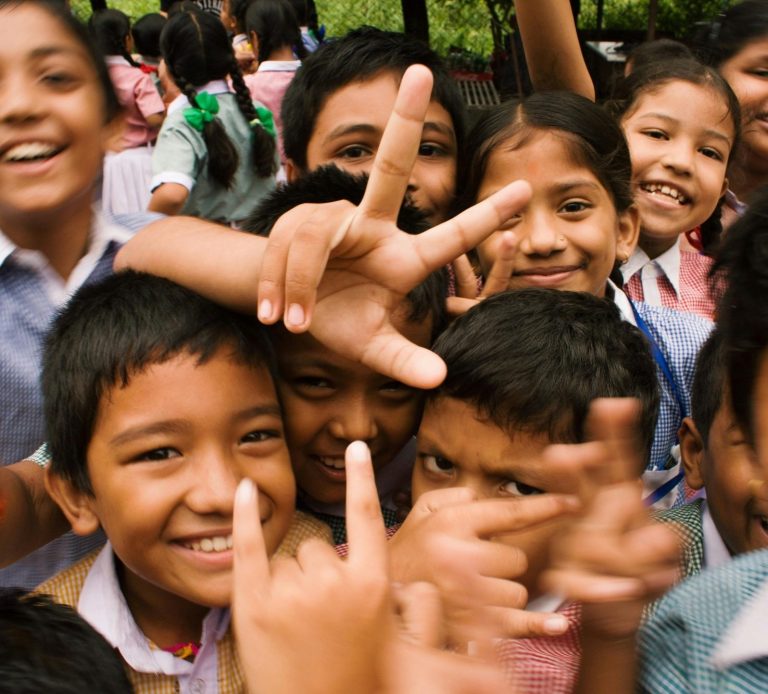 Group of Smiling Children Group of smiling children posing and making hand gestures outdoors.